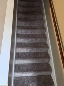 A clean light-colored hallway carpet with visible cleaning lines after professional service by Hampton Carpet Cleaning Pros in Hampton, VA.
