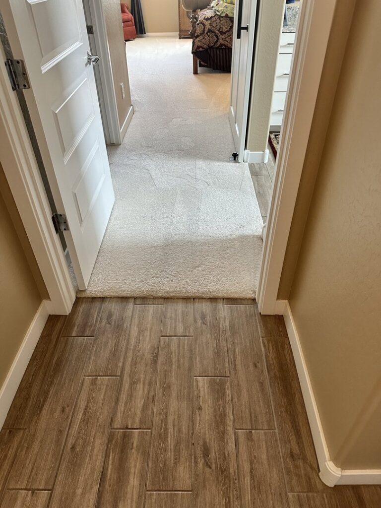 A clean hallway carpet with visible cleaning lines after service by Healthy Living Carpet & Tile Cleaning in Peoria, AZ.