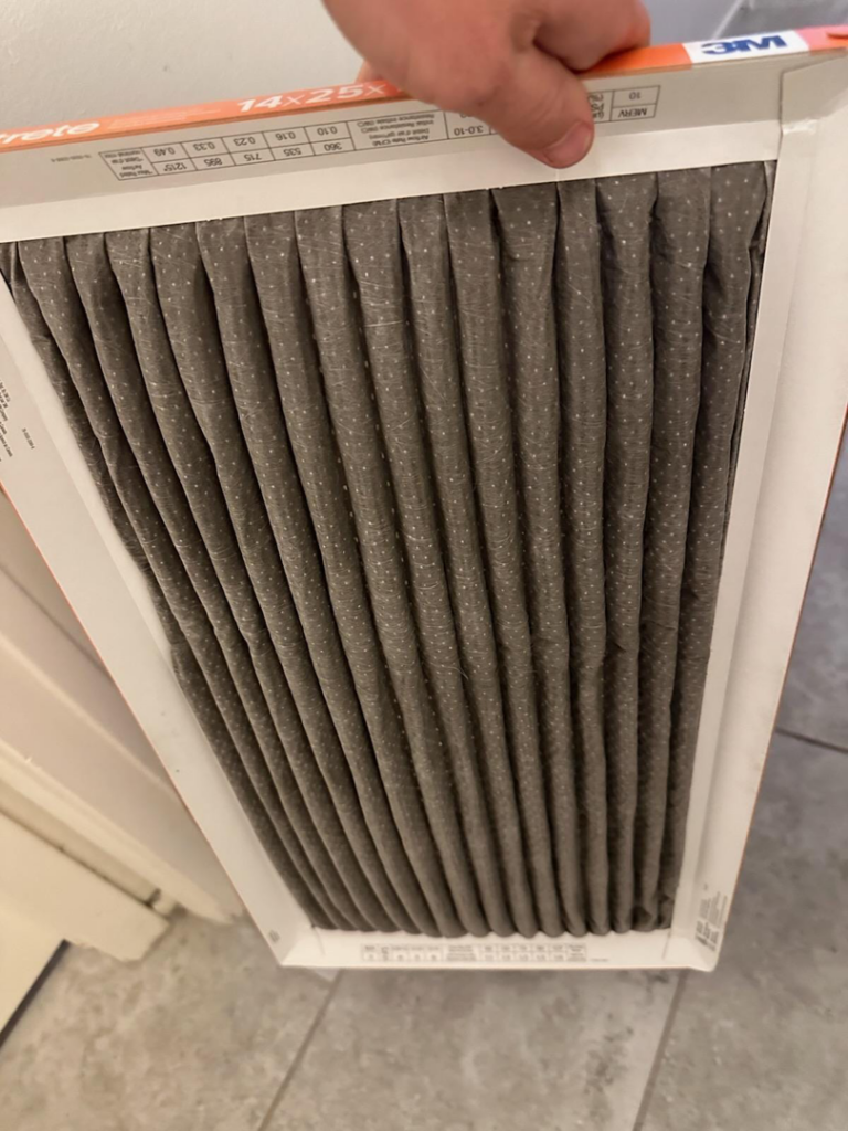 A new, clean HVAC air filter ready for installation by Cardinal State in Mesa, AZ.
