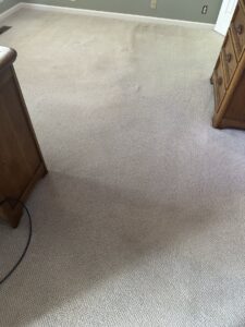A clean light-colored carpet in a room with wooden furniture, showcasing work by Safe-Dry Carpet Cleaning of Clarksville, TN
