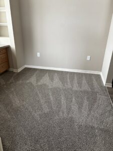A room showcasing clean, light grey patterned carpet with distinct vacuum lines by 307 Spotless Solutions in Rock Springs, WY.