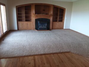A clean living room with carpet and hardwood flooring, serviced by JR Professional Carpet Cleaning Business LLC in Spokane, WA.