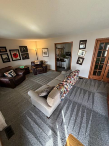 A freshly cleaned living room carpet with visible cleaning lines by Hartford's Carpet Cleaning in Toledo, OH