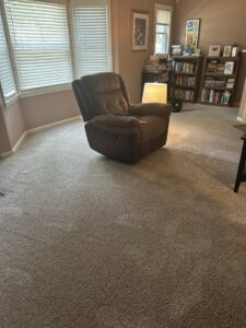 A clean, light-colored living room carpet after professional service by Strictly Tile & Carpet Care in Lansing, MI.