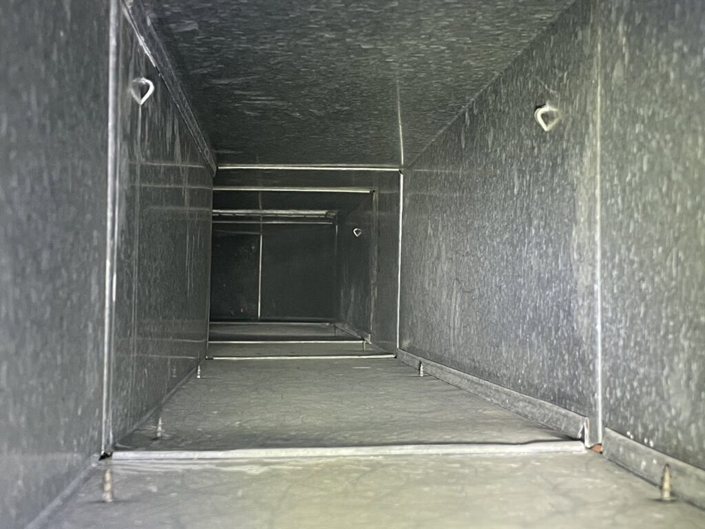 A view inside a clean metal air duct after thorough cleaning by Vacman Air Duct Cleaning in South Bend, IN