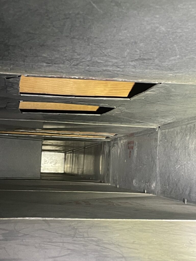 A view inside a clean metal air duct, showcasing the thorough cleaning by Vacman Air Duct Cleaning in South Bend, IN