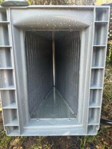 A clean outdoor air conditioning coil after maintenance by Zippers Heating and Cooling in Mobile, AL.