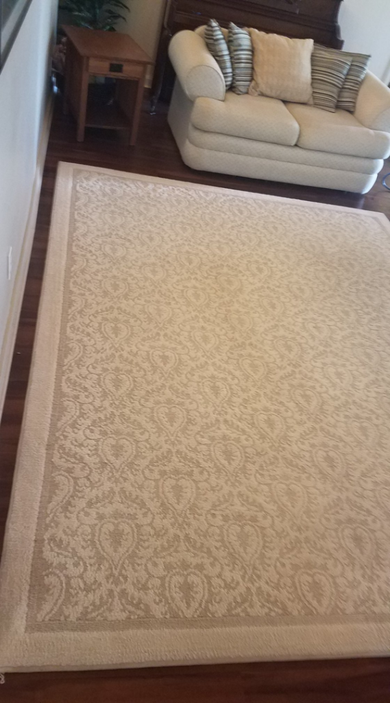 A clean, patterned area rug on a hardwood floor, showcasing services by Haine Floor Care in Honolulu, HI
