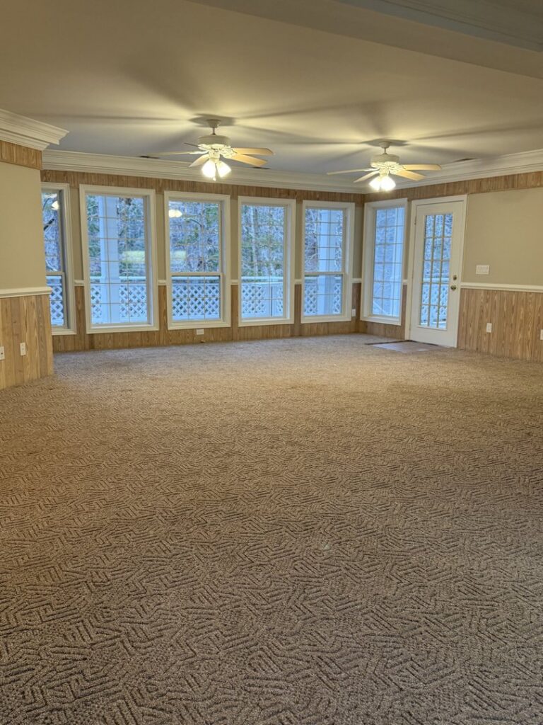 A spacious living room with a freshly cleaned, patterned brown carpet by Zerorez Columbia in Columbia, SC.