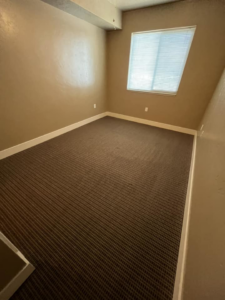 A room with clean, patterned brown carpet, showcasing the quality work of Sawtooth Carpet Cleaning in Nampa, ID.