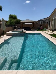A clean, inviting pool and spa with an outdoor living area, reflecting the quality pool maintenance by Space Ranger Pools in Gilbert, AZ.