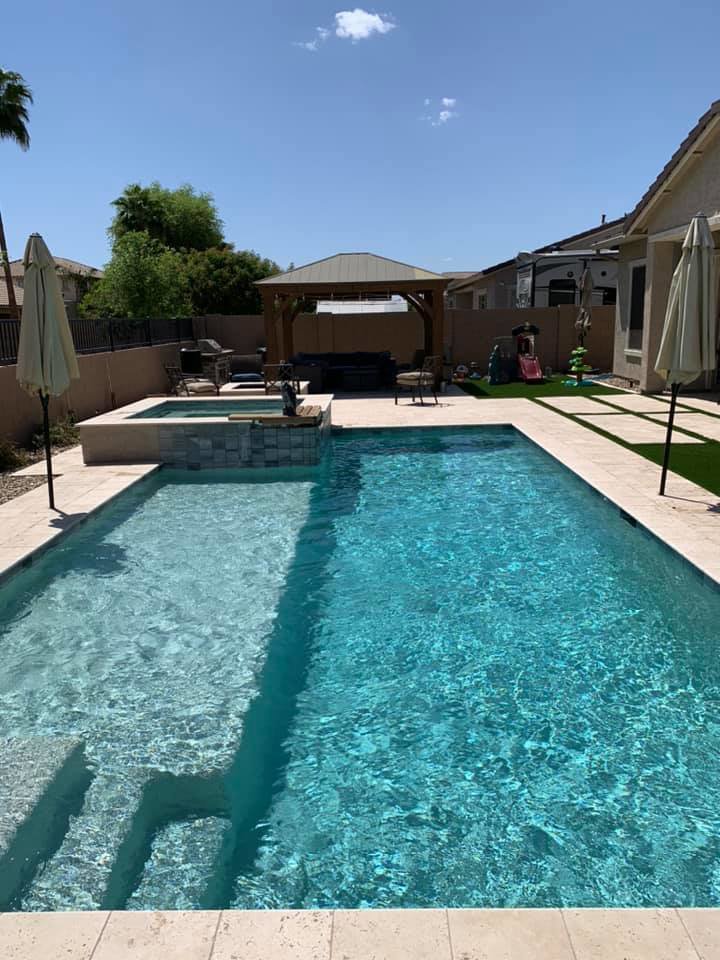 A clean, inviting pool and spa with an outdoor living area, reflecting the quality pool maintenance by Space Ranger Pools in Gilbert, AZ.
