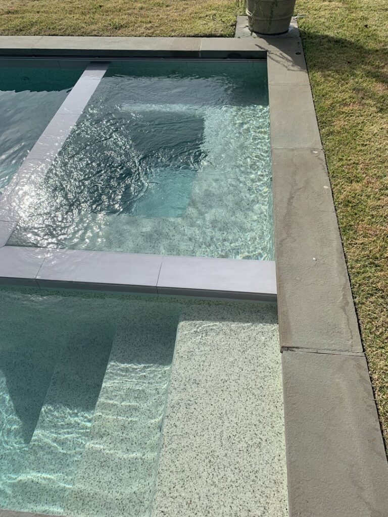 Close-up of clean pool steps and crystal-clear water, showcasing Pool King's service in Southhold, NY.