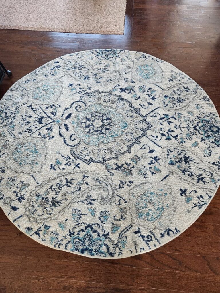 A clean round area rug with a blue and white pattern by Roberts Cleaning Services in Zionsville, IN.