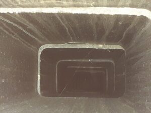 An interior view of a clean, square chimney flue, demonstrating the results of a professional chimney sweep by Colombus Chimney in Elizabeth, NJ.