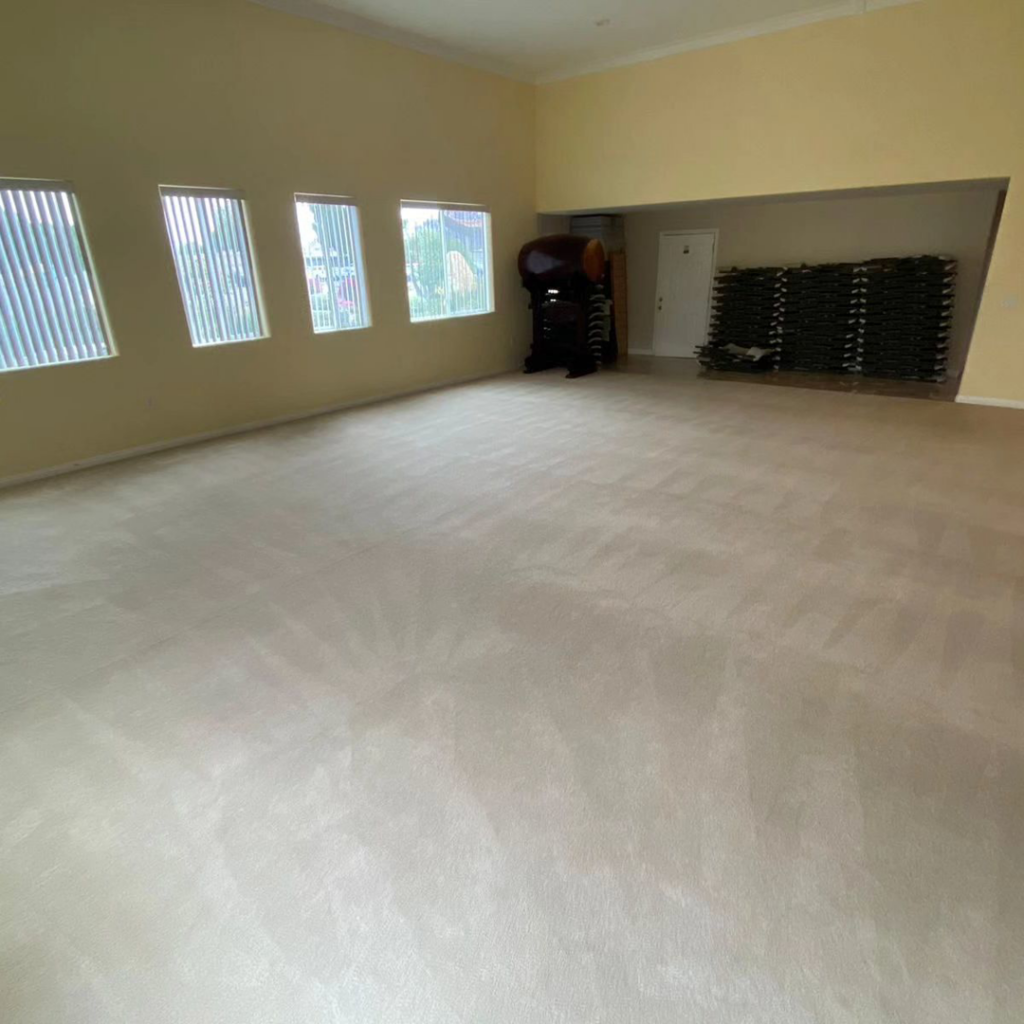 A large room with freshly cleaned wall-to-wall carpet by GTS future cleaning services in Los Angeles, CA