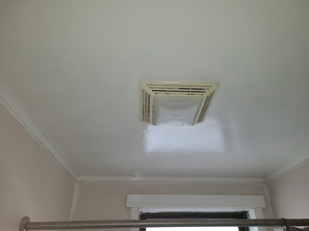 A clean bathroom ceiling with an exhaust fan after successful mold remediation by Air Care & Restoration Co. in Bethlehem, PA.