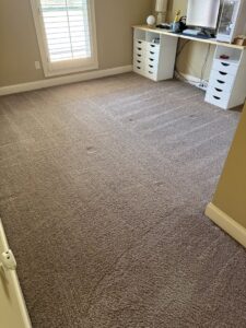 A room with freshly cleaned brown carpet showing distinct cleaning lines by Reynolds Carpet Care in Henrico, VA.
