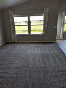 A room with carpet tiles showing fresh cleaning lines after service by Spot On Carpet Cleaning of Columbia, SC.