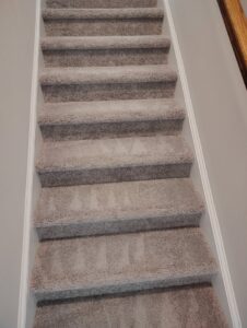 A freshly cleaned carpeted staircase with distinct cleaning patterns by D&D Carpet Cleaning & Janitorial in West Columbia, SC