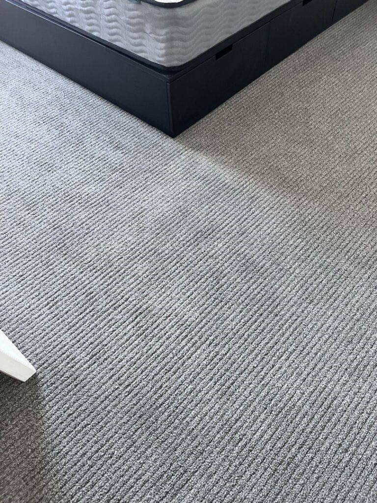 A freshly cleaned grey bedroom carpet with visible vacuum lines by Ready2go Professional Carpet & Upholstery Cleaning in Boston, MA