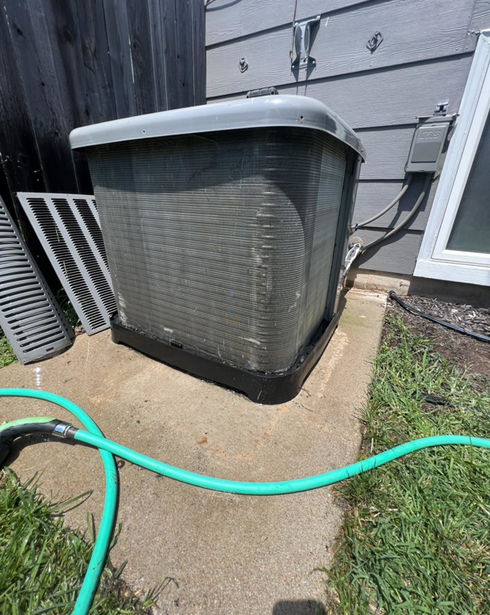 A freshly cleaned outdoor AC condenser unit after professional service by Noble Heating And Cooling in Wichita, KS.