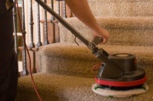 A close-up of a professional cleaning machine being used on carpeted stairs by Heaven's Best Carpet Cleaning in Fargo, ND.