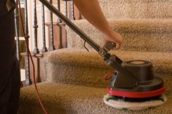 A close-up of a professional cleaning machine being used on carpeted stairs by Heaven's Best Carpet Cleaning in Fargo, ND.