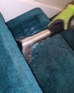 A professional cleaning technician cleaning carpeted stairs in progress for GreenLine Carpet Cleaning in Aurora, CO.