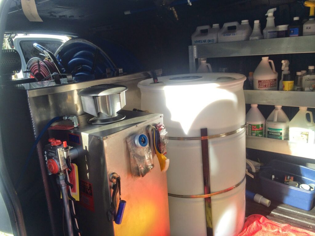 Various cleaning chemicals and equipment organized inside a Dirt Blasters Carpet Cleaning Inc. van in Atlanta, GA
