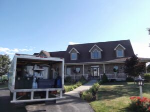 A Jason Lostetter Carpet Cleaning truck with equipment visible, parked at a client's home in New Glarus, WI.