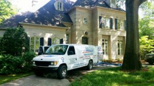 Metro Steamway Inc. cleaning van parked at a residential job site with hoses running to the house in Charlotte, NC.