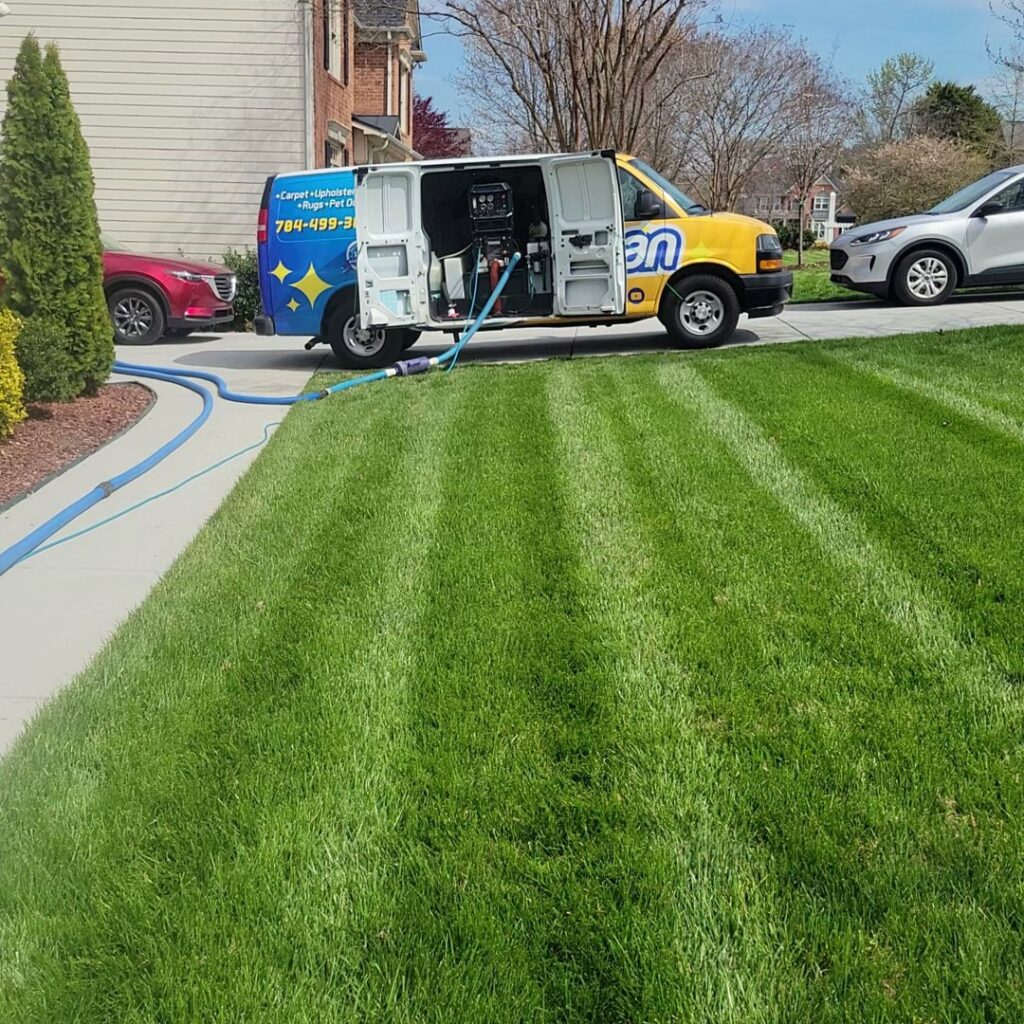 A True Organic Carpet Cleaning van with hoses extended for a residential job in Charlotte, NC.