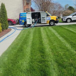 A True Organic Carpet Cleaning van with hoses extended for a residential job in Charlotte, NC.