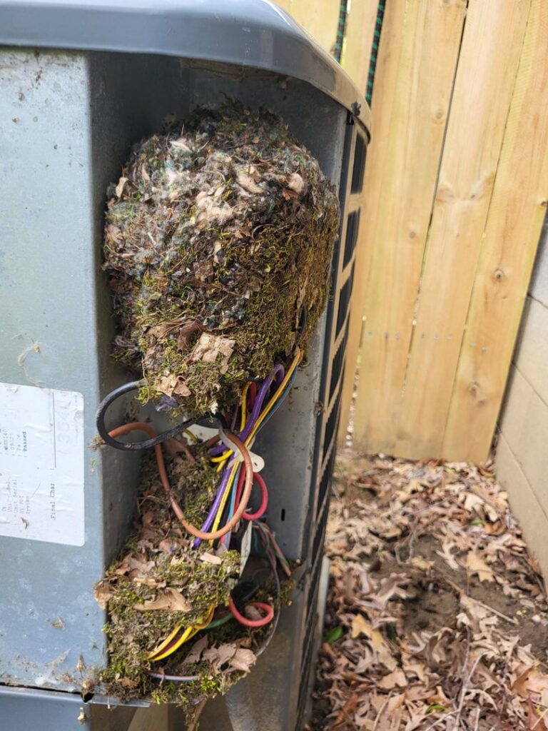 A severely clogged and dirty outdoor air conditioning unit requiring repair from Griffin HVAC in Peoria, IL