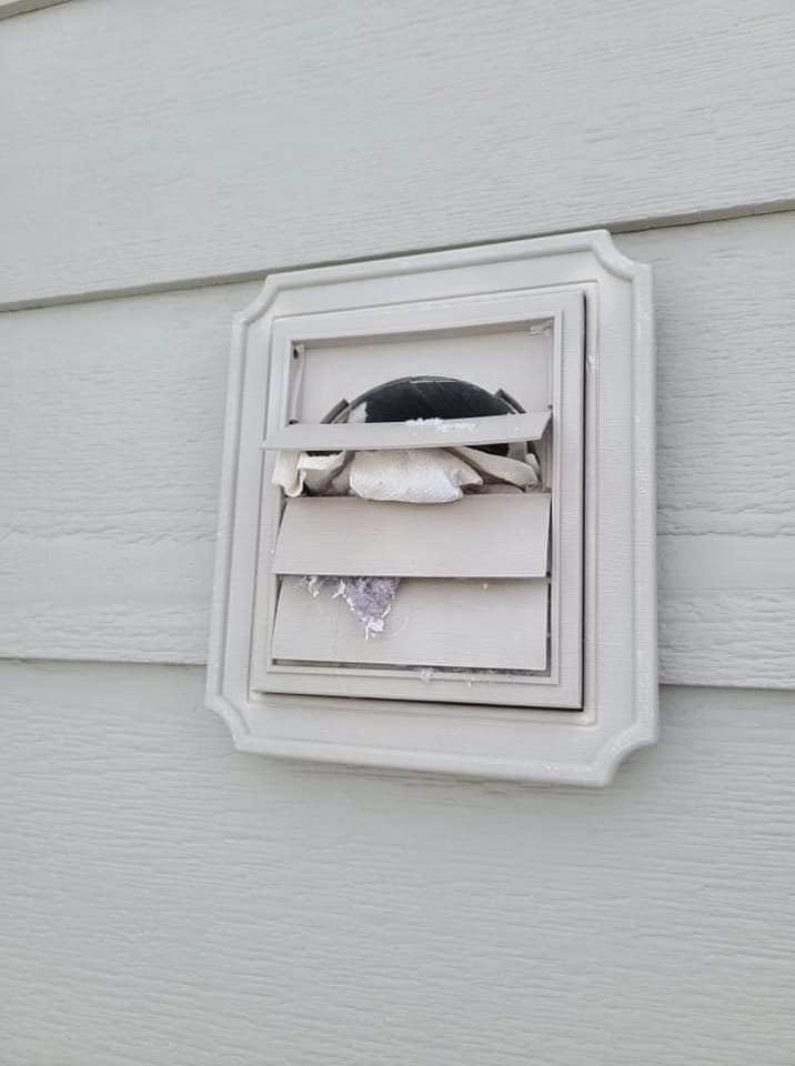 A clogged exterior dryer vent cover showing lint buildup, indicating a need for cleaning by Aero Brush Duct Cleaning in Billings, MT.