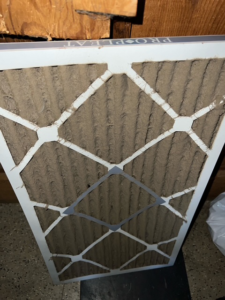 A clogged HVAC air filter, demonstrating the importance of regular maintenance by Elite Air Pros in Yukon, OK.