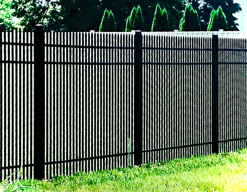 A close-up view of a black aluminum fence with white post caps by Mercer Fence Company in Hamilton Township, NJ.