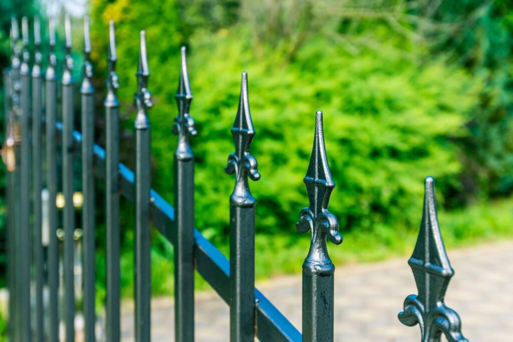 A close-up view of decorative black iron fence finials installed by Ironcraft Welding in Chicago, IL.