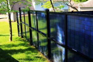 A close-up view of blue solar fence panels, showcasing the product of Sol Fence LLC in Evansville, IN.