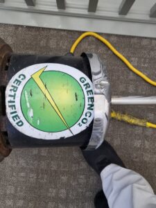 A close-up shot of a carpet cleaning machine working on a textured carpet by Greenco2 in Grand Rapids, MI.