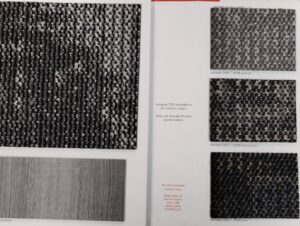 A close-up view of various carpet samples displayed in a catalog at Floors To Go in Lighthouse Point, FL
