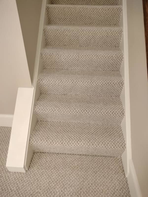 Close-up view of newly installed light-colored carpet on stairs by Amazonia Floors in bel air, Baldwin, MD.