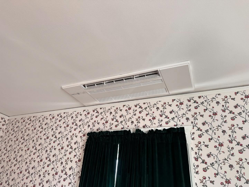A close-up view of a modern ceiling-mounted HVAC unit installed by ComfortCool Mass in Quincy, MA
