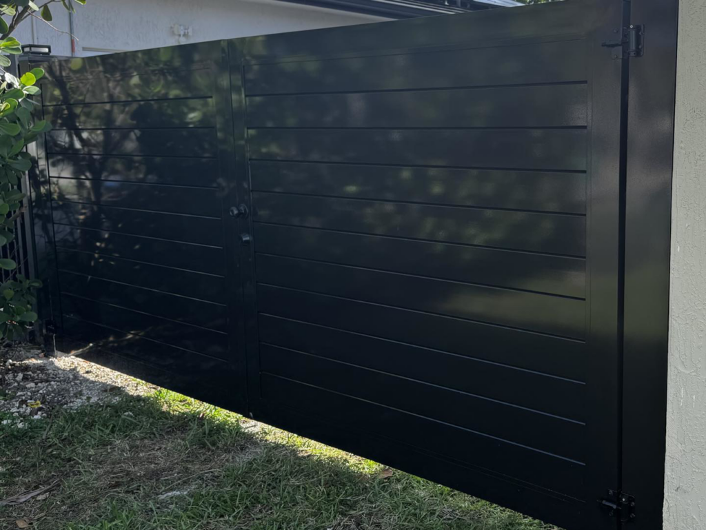 A close-up view of a dark grey horizontal slat gate, part of a fence installation by HD Multi Service USA INC in Miami, FL.