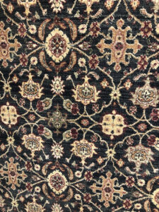 A close-up view of a dark patterned rug available at Rug Masters in Charleston, SC.