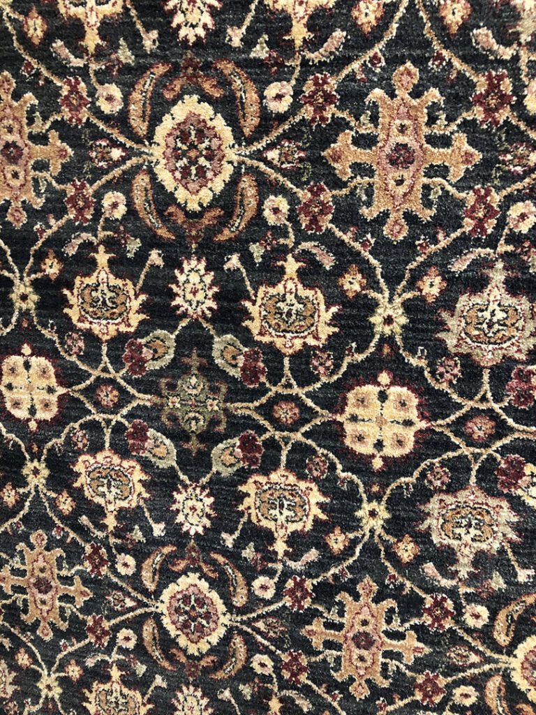 A close-up view of a dark patterned rug available at Rug Masters in Charleston, SC.