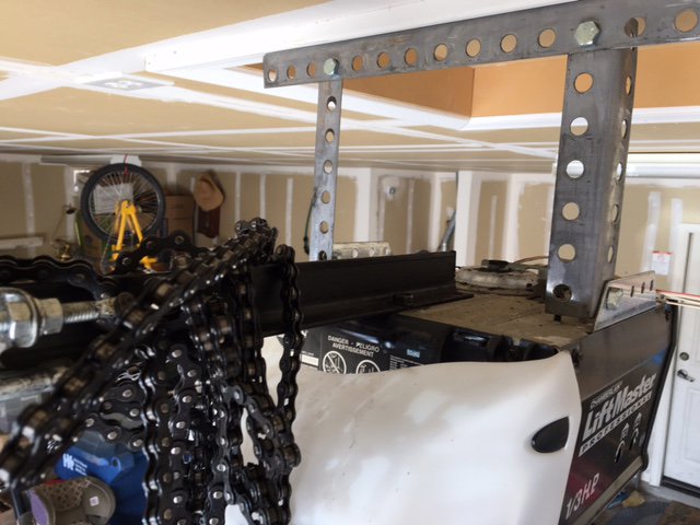 A close-up view of a garage door opener motor and chain mechanism, indicating service by Able Garage Door Service, LLC in Tucson, AZ.