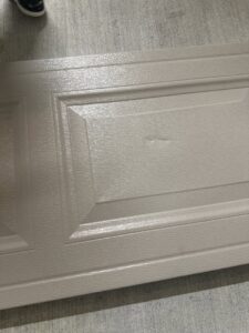A close-up view of a textured garage door panel, showcasing quality materials from Legacy Garage Doors & Repairs in Church Point, LA.