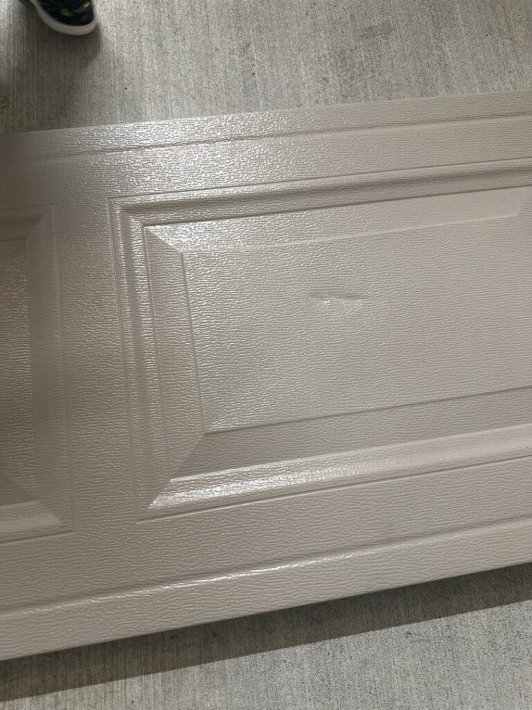 A close-up view of a textured garage door panel, showcasing quality materials from Legacy Garage Doors & Repairs in Church Point, LA.